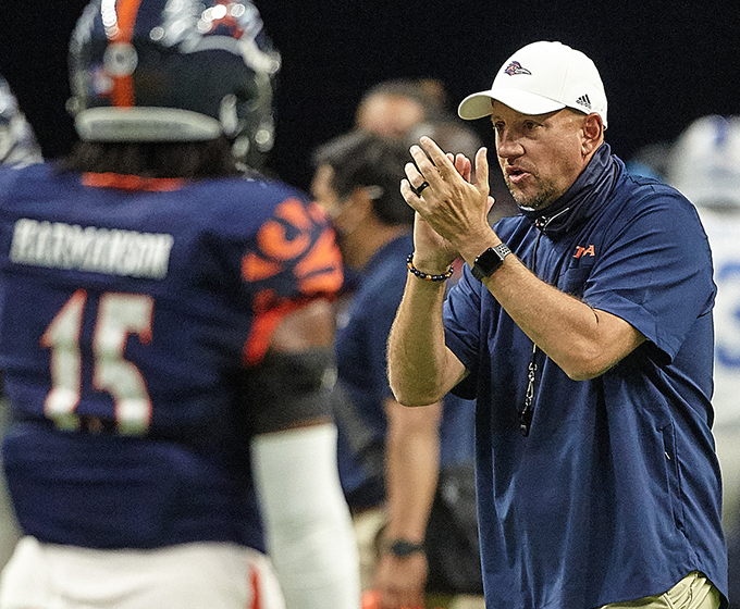 Coach Traylor clapping on sidelines